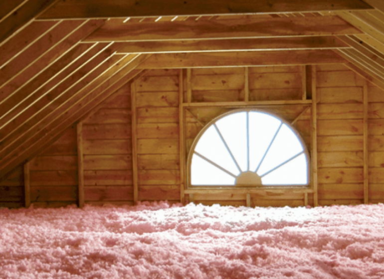 An attic with improved insulation and a window.
