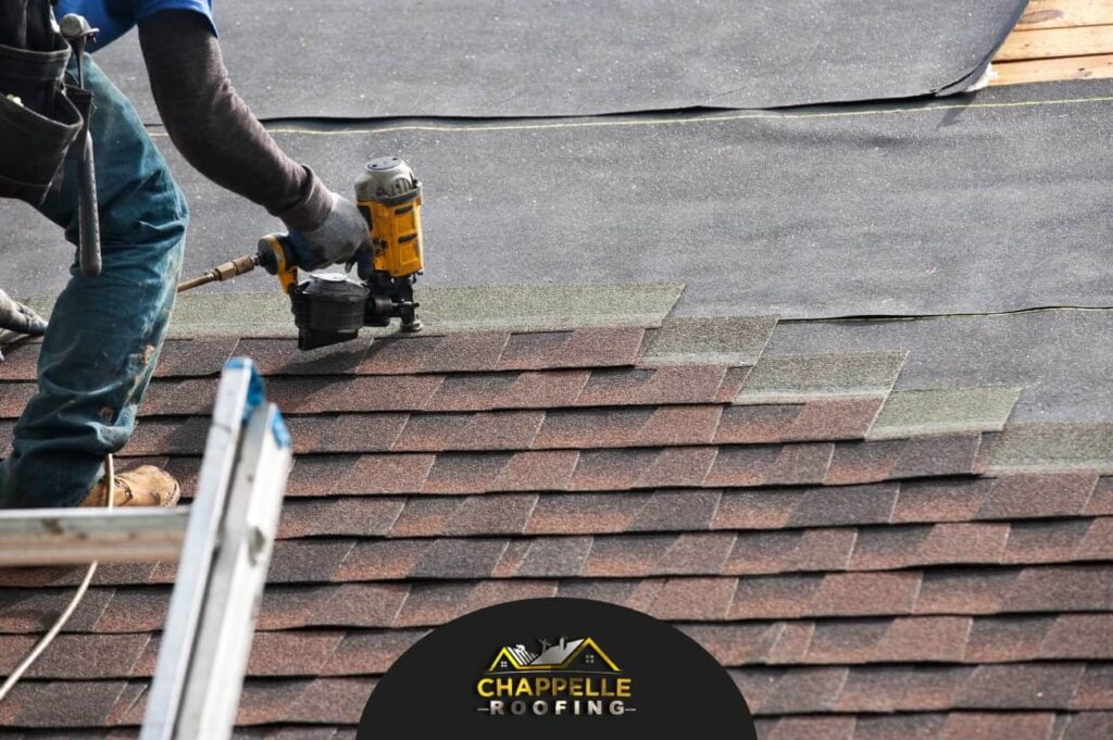 A residential roofer in North Port, FL is working on a shingled roof.