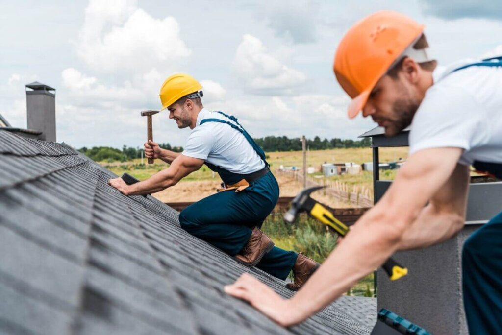 Two roofing contractors during a roofing inspection.