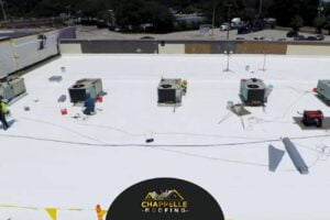 An aerial view of a roof with several air conditioning units undergoing commercial roof repair in Florida.