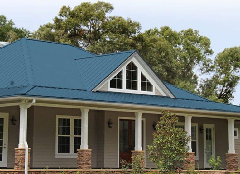 A clean home with a blue metal roof.