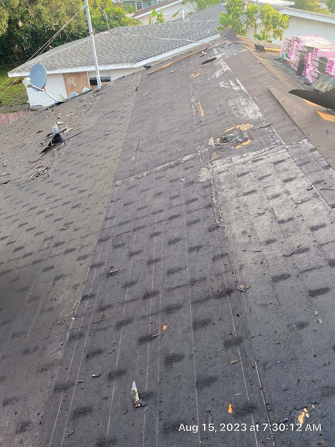 A roof that needs repair work with a new shingle.