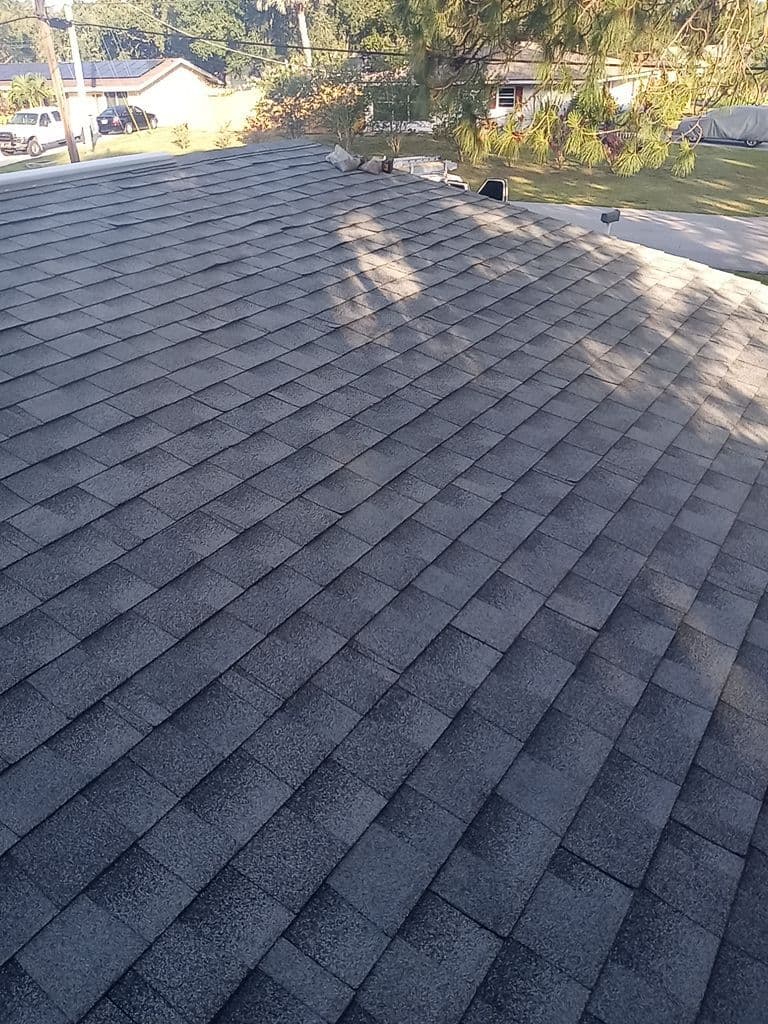 A black shingled roof after repair.